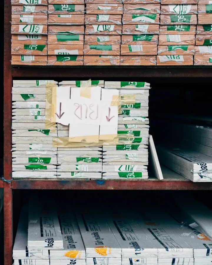 Building materials arranged on warehouse shelving