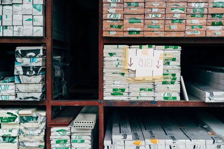 Building materials arranged on warehouse shelving