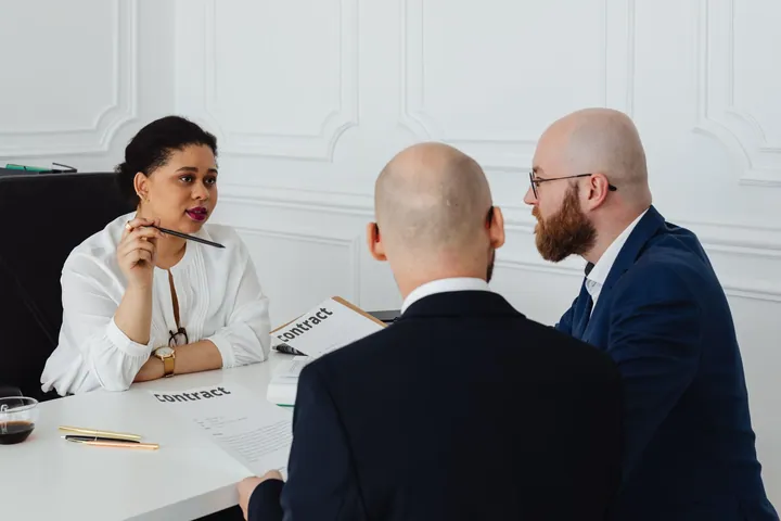 People discussing documents at a business table